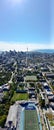 Vertical cityscape with the CN Tower on the horizon in Toronto with blue sunny sky