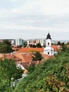 Vertical cityscape view with red-tiled buildings and the Castle of Eger in Hungary