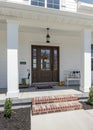 Vertical Classic front porch of a house with white siding exterior