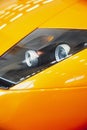 Vertical close shot of an orange sports car headlight Royalty Free Stock Photo