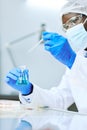 African American lab technician taking liquid samples with pipette Royalty Free Stock Photo