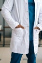 Vertical close-up cropped shot of unrecognizable confident African American male doctor wearing medical lab uniform