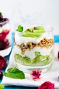 Vertical close-up of healthy vegan Breakfast, kiwi dessert, granola and ricotta cheese