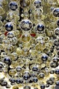 Vertical close-up image of dozens of shiny reflective glass bubbles on a amazing pattern