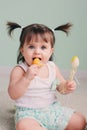 Vertical close up indoor portrait of cute baby girl playing with easter decorations Royalty Free Stock Photo