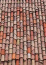 Vertical close-up of old weathered red and orange roof tiles. Royalty Free Stock Photo