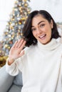 Vertical close-up photo of a young woman talking on a video call with her parents, friends, wishing her happy New Year Royalty Free Stock Photo