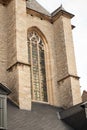 Vertical close-up picture of exterior and stained glass window of Cathedral of Our Lady in Antwerp, UNESCO world heritage site in