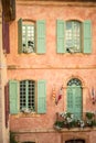 Vertical close-up picture of town hall in Roussillion, Provence, France. Old historical building with orange walls and green Royalty Free Stock Photo