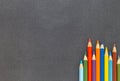 Colored pencils on dark background top view Royalty Free Stock Photo