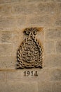 Vertical close-up shot of an engraving on an aged building in Mardin City