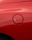 Vertical close-up shot of the luxury Italian red Ferrari gas tank