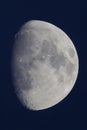 Vertical close-up shot  of Three Quarter moon in a black night sky  background Royalty Free Stock Photo