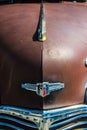 Vertical close-up shot of a vintage rusty Chevrolet on a sunny day