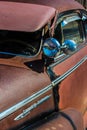 Vertical close-up shot of a vintage rusty Chevrolet on a sunny day