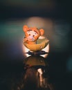 Vertical close-up of a Tigger sitting in an umbrella, floating on the water