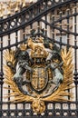 Vertical close-up view of golden Buckingham Palace gates.