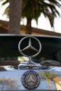 Vertical close-up view of a Mercedes Benz classic car frontal logo