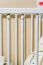 Vertical closeup of a baby cradle metallic handrail