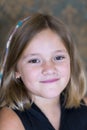 Vertical closeup of beautiful little girl in black with shoulder-length bobbed hair Royalty Free Stock Photo