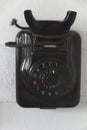 Vertical closeup of a black vintage telephone without a handset on the table Royalty Free Stock Photo