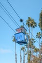 Vertical closeup of a blue Bayside skyride between palm trees in San Diego Royalty Free Stock Photo
