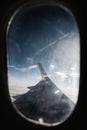 Vertical closeup of a blue sky and white light from a part from plane window