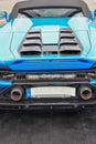 Vertical closeup of a blue sports car Lamborghini standing on the road