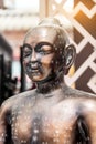 Vertical closeup of a bronze acupuncture buddhist sculpture with Chinese engravings Royalty Free Stock Photo