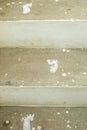 Vertical closeup of cement stairs with a baby's footprint painted on each step