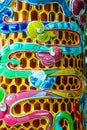 Vertical closeup of ceramic mosaic from a pagoda in Vietnam.
