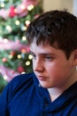 Vertical closeup of cute glum round-faced teenager boy