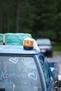 Vertical closeup of a decorated vintage blue wedding car