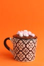 Vertical closeup of a delicious hot cocoa drink in a mug with marshmallows on top