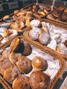 Vertical closeup of different types of bread in straw baskets Royalty Free Stock Photo