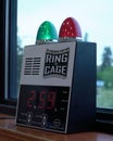 Vertical closeup of an electronic boxing bell with a countdown timer on a windowsill