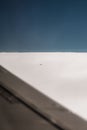 Vertical closeup of a faraway little plane seen from above