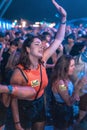 Vertical closeup of a female enjoying during Electric Love Festival, crowd blurred background