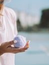 Vertical closeup of a female holding a tennis ball in her hand - tennis concept Royalty Free Stock Photo