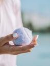 Vertical closeup of a female holding a tennis ball in her hand - tennis concept Royalty Free Stock Photo