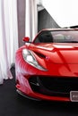 Vertical closeup of Ferrari 812 superfast front view cut in half, in the showroom