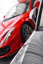 Vertical closeup of Ferrari 812 superfast front view cut in half, in the showroom