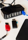 Vertical closeup of the flash drive, external drive, and multiple USB ports charger on a desk Royalty Free Stock Photo