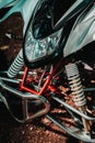 Vertical closeup of the front part and light of a quad bike