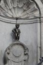 Closeup on Manneken pis national Belgian statue, a sculpture fountain of a pissing boy