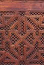 Vertical closeup of a Moroccan carved wood panel on a door