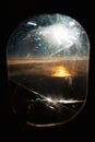 Vertical closeup of a night view from a plane window with a moon illuminating an orange surface Royalty Free Stock Photo