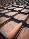 Vertical closeup on old , dirty rooftiles neatly lined up in a pattern on a roof of an older house