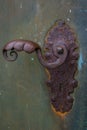 Vertical closeup of an old rusty vintage door lock with handle Royalty Free Stock Photo