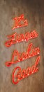 Vertical closeup of an orange neon color quote on a brown grungy wall